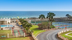 A resort with a swimming pool, tennis courts, and a view of the ocean. - Inlet Reef 318 (Destin)