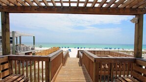 A wooden deck leading to a beach with a clear view of the ocean. - Chateau La Mer II #103- Dreamland Destin (Destin)