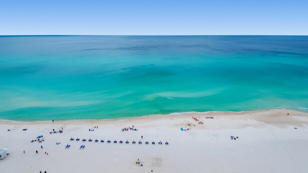 A beach with clear turquoise waters and a sandy shore. - Majestic Beach Towers 1-1804 (Panama City Beach)