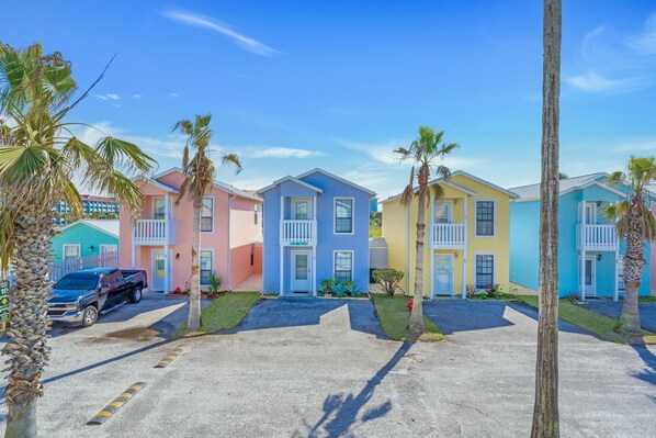 A row of colorful houses with a truck parked in front.