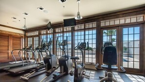 A gym with treadmills, stationary bikes, and elliptical machines.