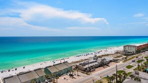 A coastal town with a beach, buildings, and a road. - Leeward Key 1201 (Miramar Beach)