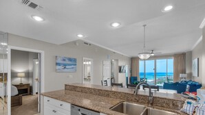 A modern kitchen with granite countertops, a dishwasher, and a sink. - Leeward Key 1201 (Miramar Beach)