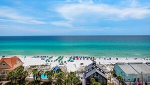 A beach view with a clear sky, a sandy beach, and a calm sea. - Leeward Key 904 (Miramar Beach)