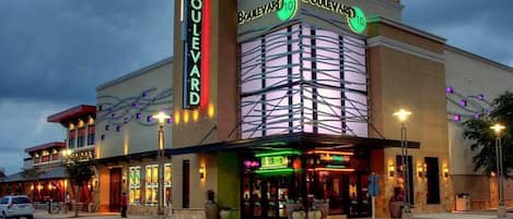 A building with a prominent 'Boulevard' sign, featuring multiple businesses including a cinema and a restaurant.
