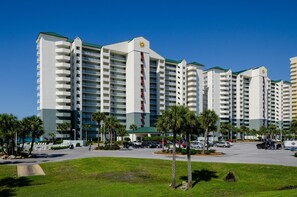 A multi-story hotel with a modern design, featuring balconies and a central vertical feature. - Long Beach Resort 1-904 (Panama City Beach)