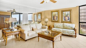 A spacious living room with two sofas, a coffee table, and a ceiling fan. - Mainsail 227 (Miramar Beach)