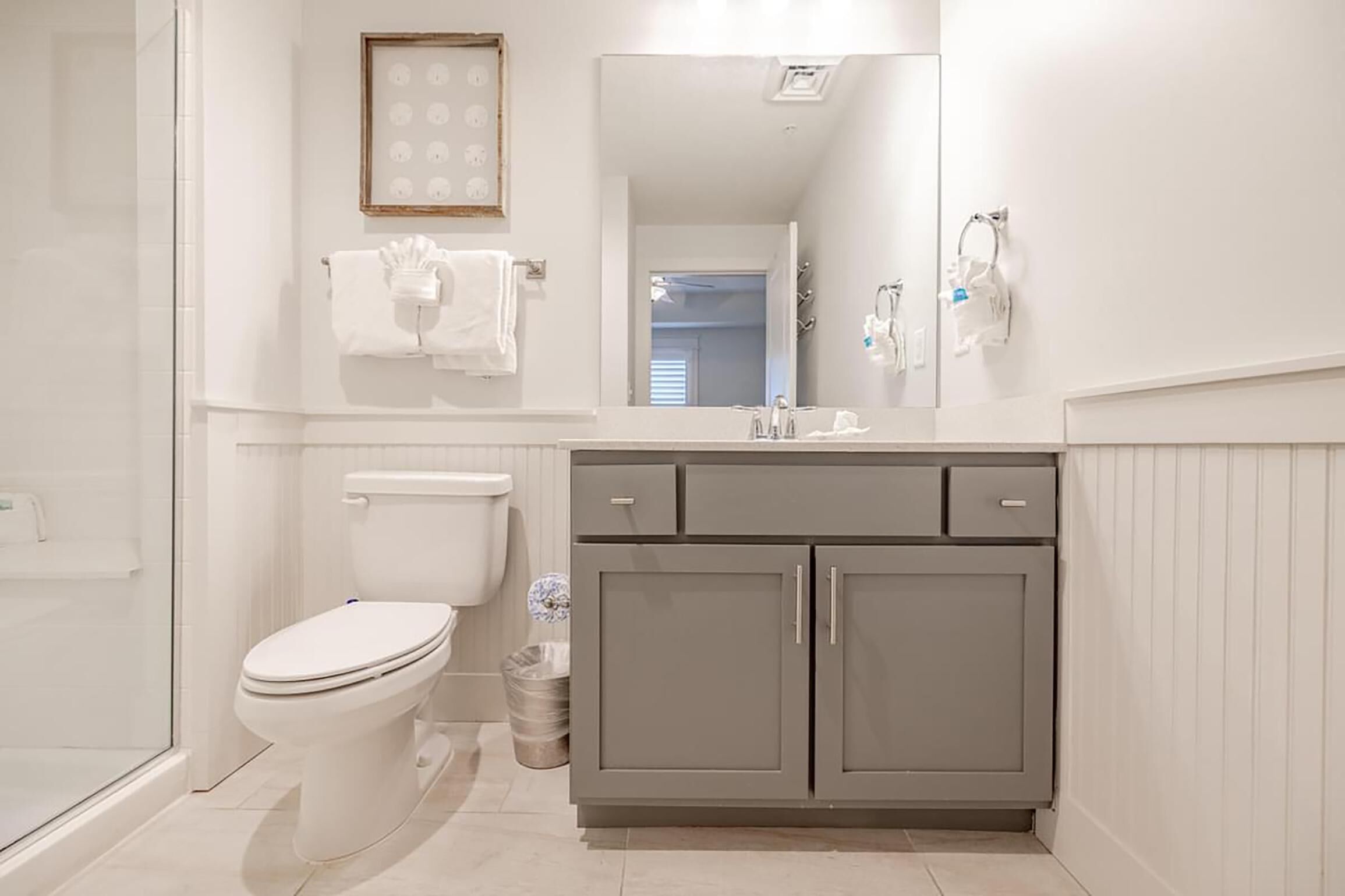 A bathroom with a toilet, a sink, and a shower.