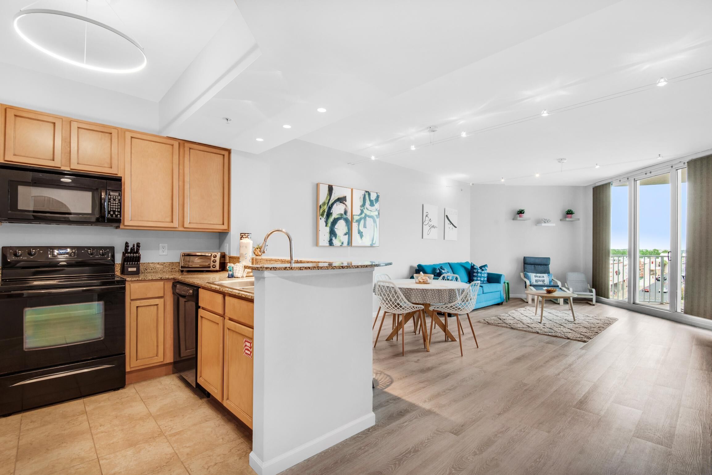 A modern apartment with a kitchen, dining area, and living room.