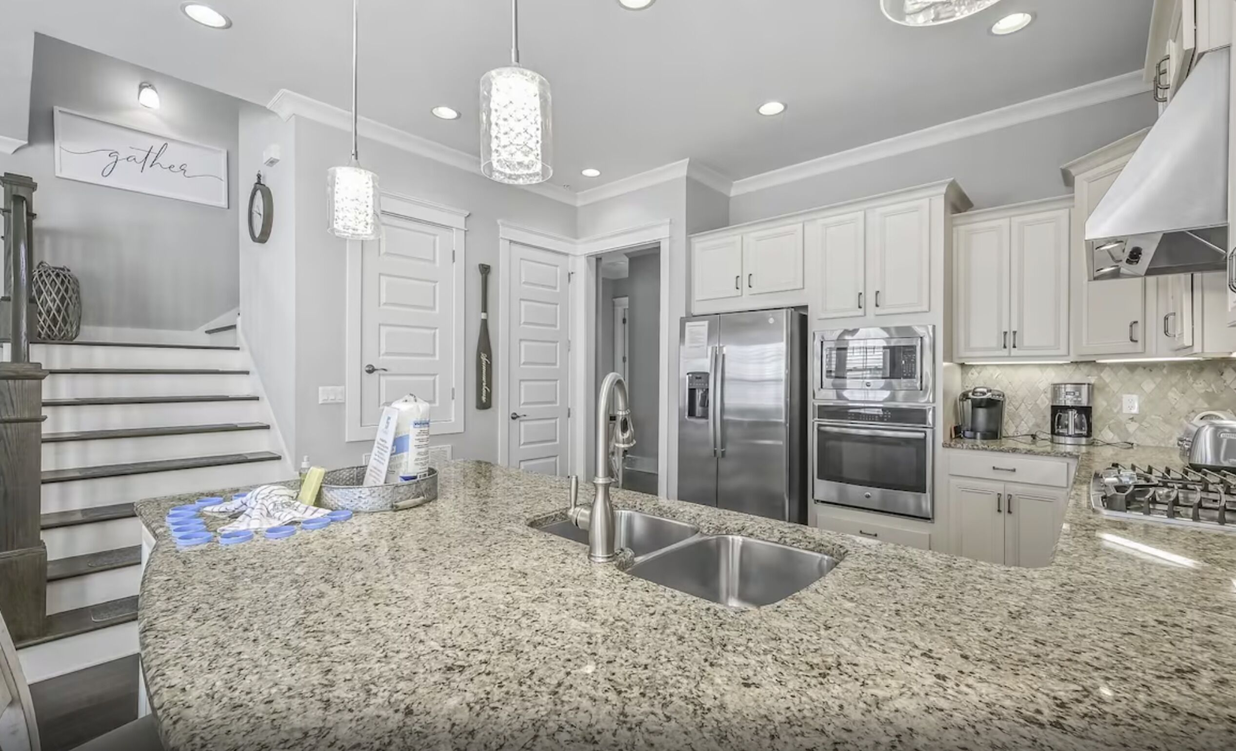 A modern kitchen with granite countertops, stainless steel appliances, and a built-in oven.