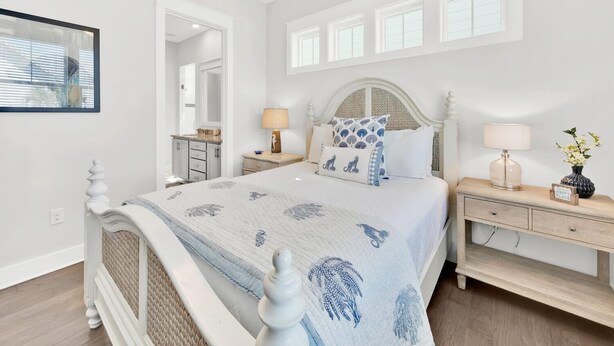 A bedroom with a bed, nightstands, a mirror, and a window. - Town of Prominence 80c- The Wright Place (Santa Rosa Beach)