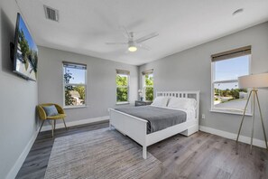 A bedroom with a bed, a ceiling fan, and large windows. - Spectacular Estate on Antique Row - Large Groups (West Palm Beach)