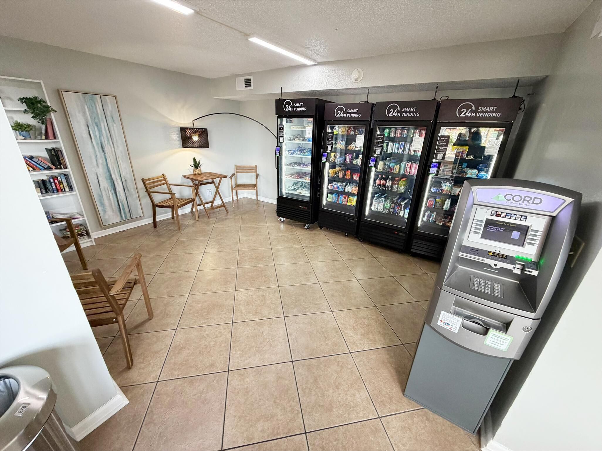 A 24-hour vending area with refrigerated beverage machines and a CORD financial services machine.