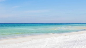 A beach with clear turquoise water and a sandy shore. - St Thomas Square Villa 1211c Beach Bumz (Panama City Beach)