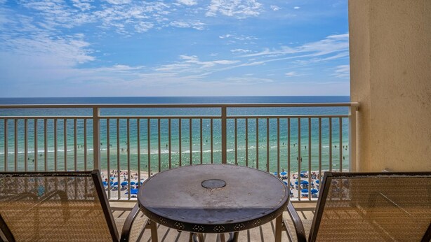 A balcony with a view of the beach and ocean. - Emerald Beach 930 (Panama City Beach)