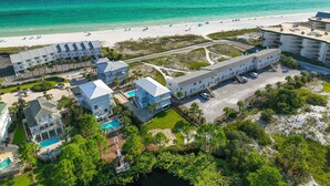 An aerial view of a resort with multiple buildings, a beach, and a pool area. - 3 Generations Beach House (Santa Rosa Beach)