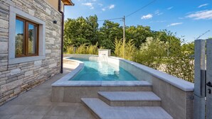 A swimming pool with steps leading up to it, surrounded by stone walls and greenery. - Casa Dika Pool & Lounge, Barban, Croatia (Barban)