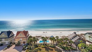 A beachfront property with multiple houses, a swimming pool, and a beach view. - Leeward Key 806 (Miramar Beach)