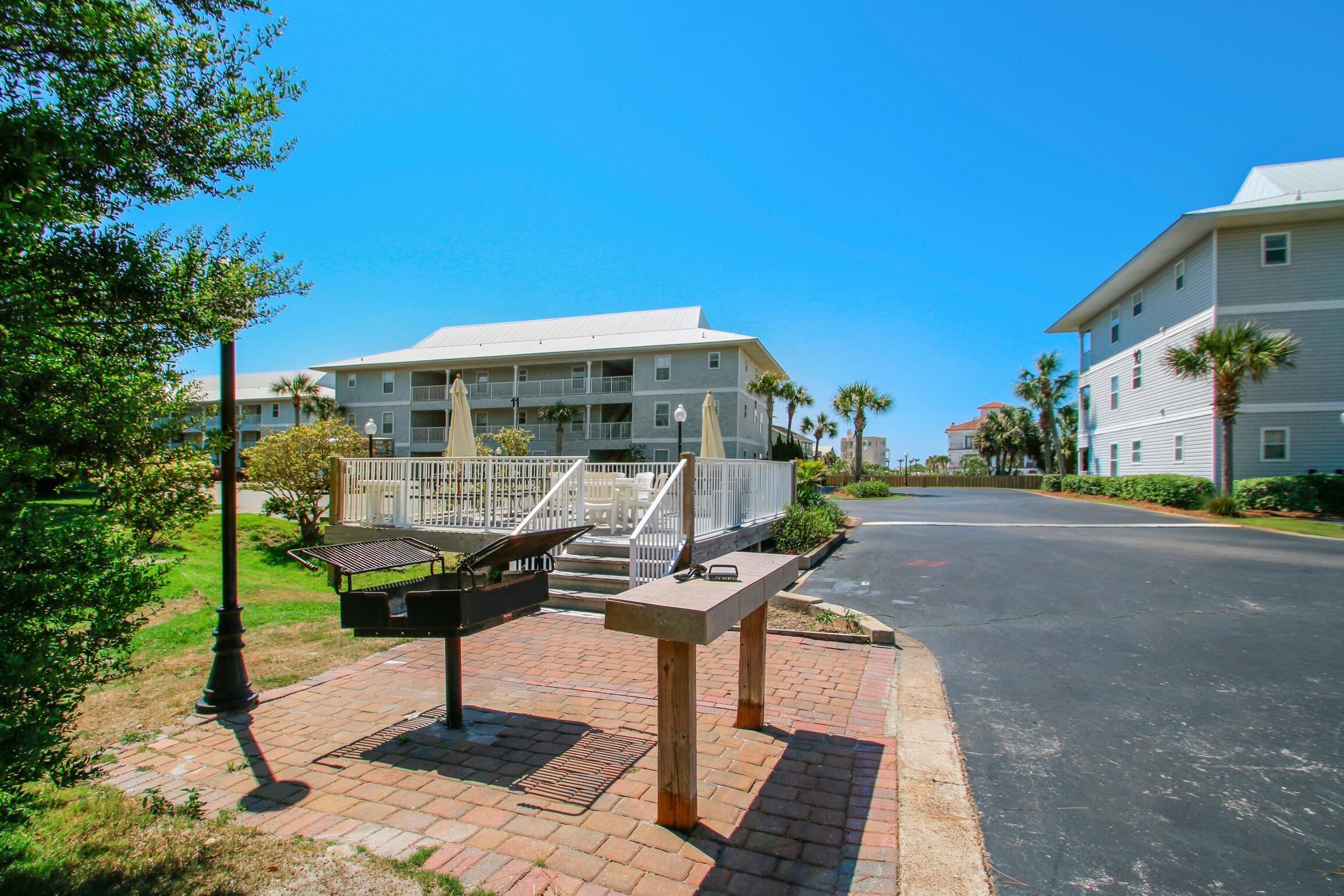 A hotel with a covered outdoor area, including a barbecue station and seating.