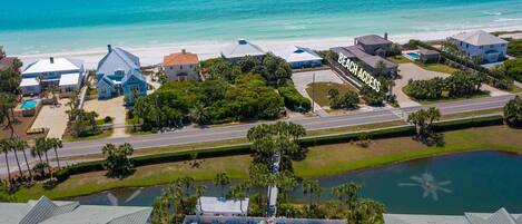 A coastal residential area with houses, a beach, and a body of water.
