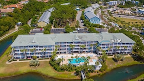 A multi-story hotel with a pool and a view of a lake. - Gulf Place Caribbean 205 - 30A Beach Getaway (Santa Rosa Beach)