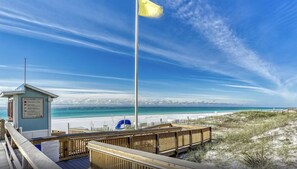 A beach with a lifeguard tower, wooden boardwalk, and a clear view of the ocean. - Captiva 67 (Miramar Beach)