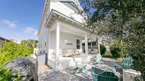 A house with a covered porch, outdoor seating, and a stone pathway. - Keeping It Reel on 30A (Santa Rosa Beach)