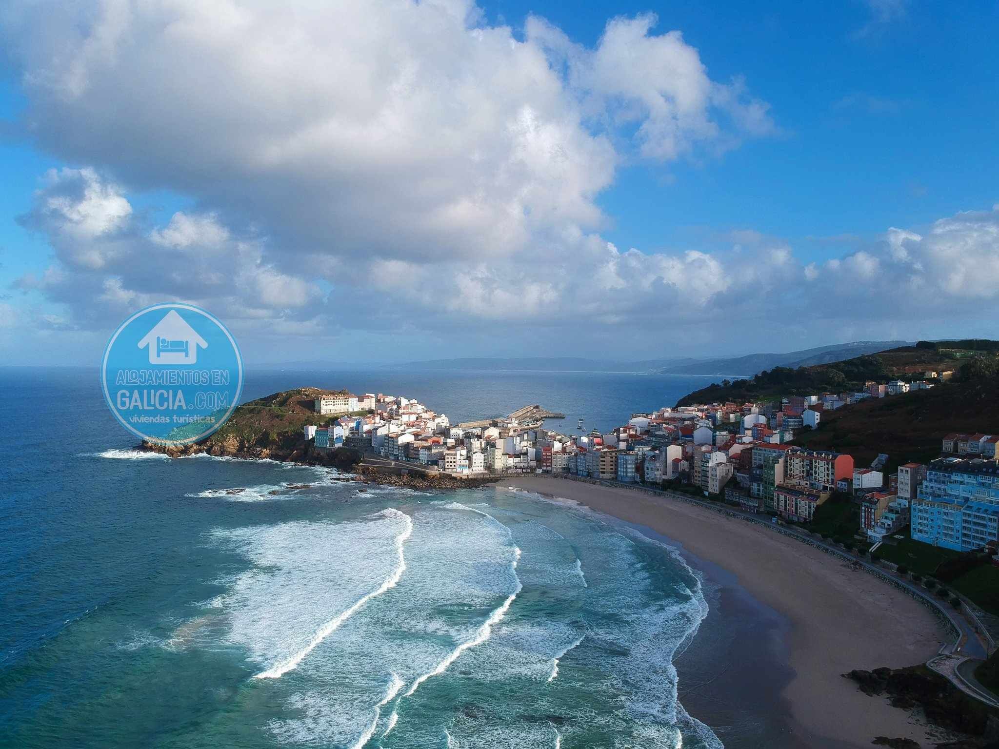 A coastal town with a beach and ocean view.