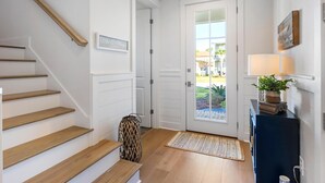 A staircase leading to a door with a view of the outside. - Once Upon a Tide (Miramar Beach)