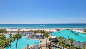 A resort with a large pool, beach access, and a view of the ocean. - Edgewater Tower 1-411 (Panama City Beach)
