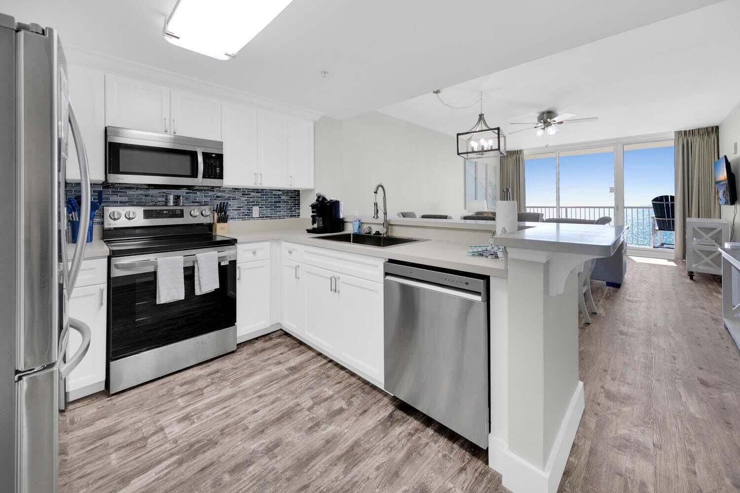 A modern kitchen with a built-in oven, microwave, and dishwasher.