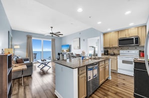 A modern kitchen with granite countertops, stainless steel appliances, and wooden cabinets.