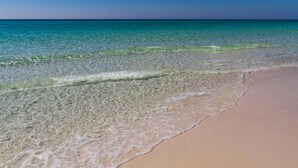 A beach with clear turquoise water and a sandy shore. - Tides at Tops'l 907 (Miramar Beach)
