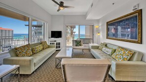 A spacious balcony with a view of the ocean, furnished with a sofa, chairs, and a table. - Luau I 7103 (Miramar Beach)