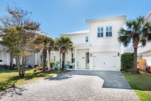 Welcome to a charming two-story home with a covered porch and inviting outdoor seating area.
