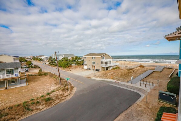 A coastal road with houses and a beach. - Sojourn Ocean View Oasis Ocean & Bay Views (Virginia Beach)