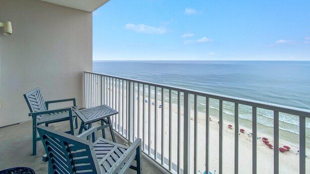 A balcony with a view of the beach and ocean. - Windemere 1204 (Pensacola)