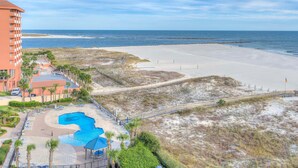 A beachfront hotel with a swimming pool, beach access, and a view of the ocean. - Phoenix East 806 (Orange Beach)