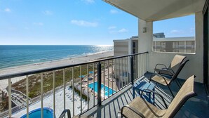 A balcony with a view of the beach and pool area. - The Breakers 61 (Orange Beach)