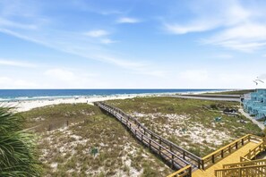 A beach view with a wooden boardwalk, sandy beach, and ocean. - Riviera Dunes 201 (Pensacola)