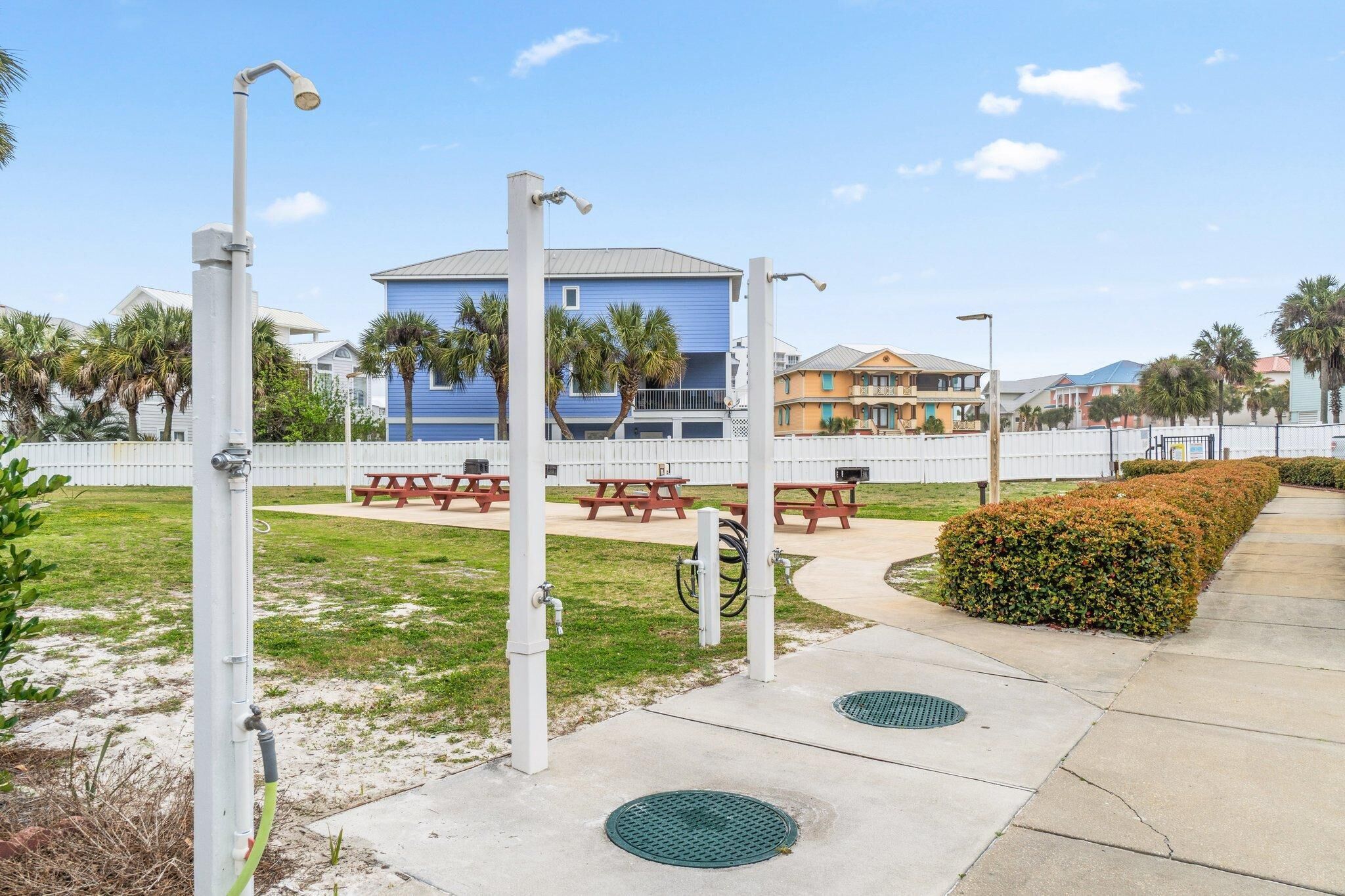 A parking area with a covered picnic table and a building in the background.
