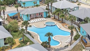 A resort with a large swimming pool, multiple lounge areas, and a variety of accommodations. - Barefoot Bungalow at Rookery (Gulf Shores)