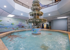 A multi-tiered indoor fountain with a mural of marine life on the walls. - Phoenix V 102 (Orange Beach)