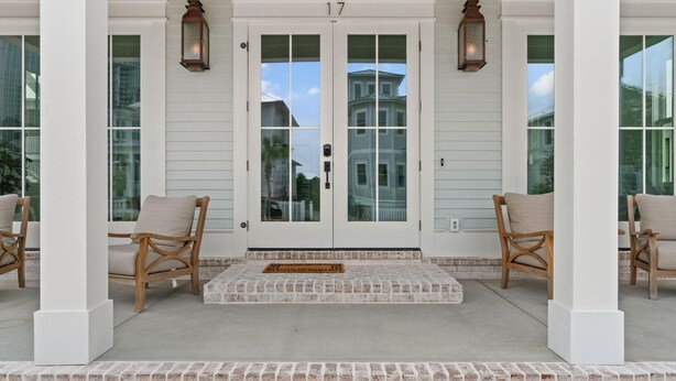A front porch with a double door marked '17', two wicker chairs, and a brick step leading to the door. - Battery 17 (Orange Beach)
