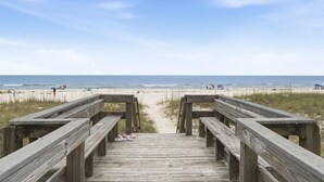 A wooden boardwalk leading to a beach with a clear sky. - Riviera Dunes 302 (Pensacola)