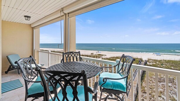 A covered outdoor seating area with a view of the beach. - Riviera Dunes 302 (Pensacola)