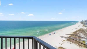 A beach view with a wooden walkway and beach umbrellas. - Broadmoor 1105 (Orange Beach)