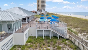 A beachfront hotel with a pool area, outdoor seating, and a view of the beach and ocean. - Slow M'ocean at Lost Key Villas (Pensacola)