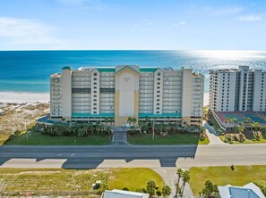 Regency Isle hotel offers stunning ocean views from its central building, situated adjacent to a beautiful beach.
