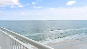 A beach view from a balcony with a railing. - Palacio Penthouse 1902 (Pensacola)